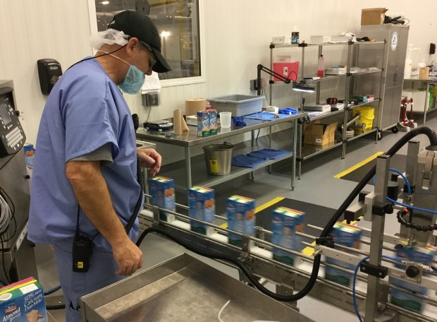 A SunOpta employee oversees a production line of Almond Breeze at the company's Upper Macungie Township facility.