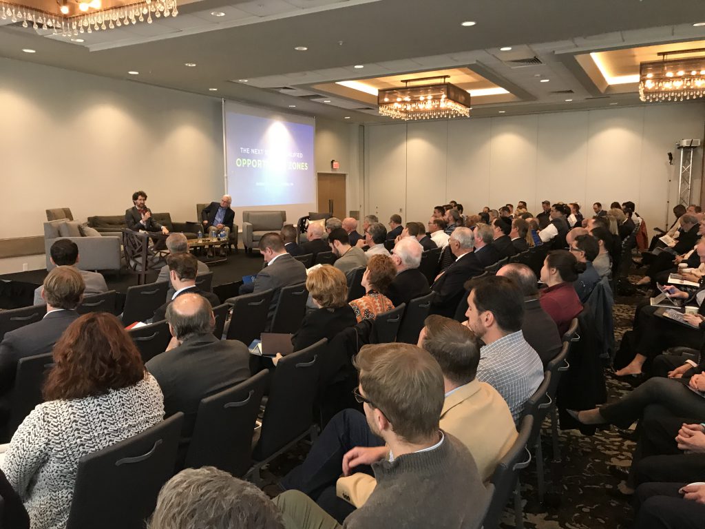 Evan Weiss, a director of PEL Analytics, speaking at a symposium on Qualified Opportunity Zones at the Allentown Renaissance Hotel.